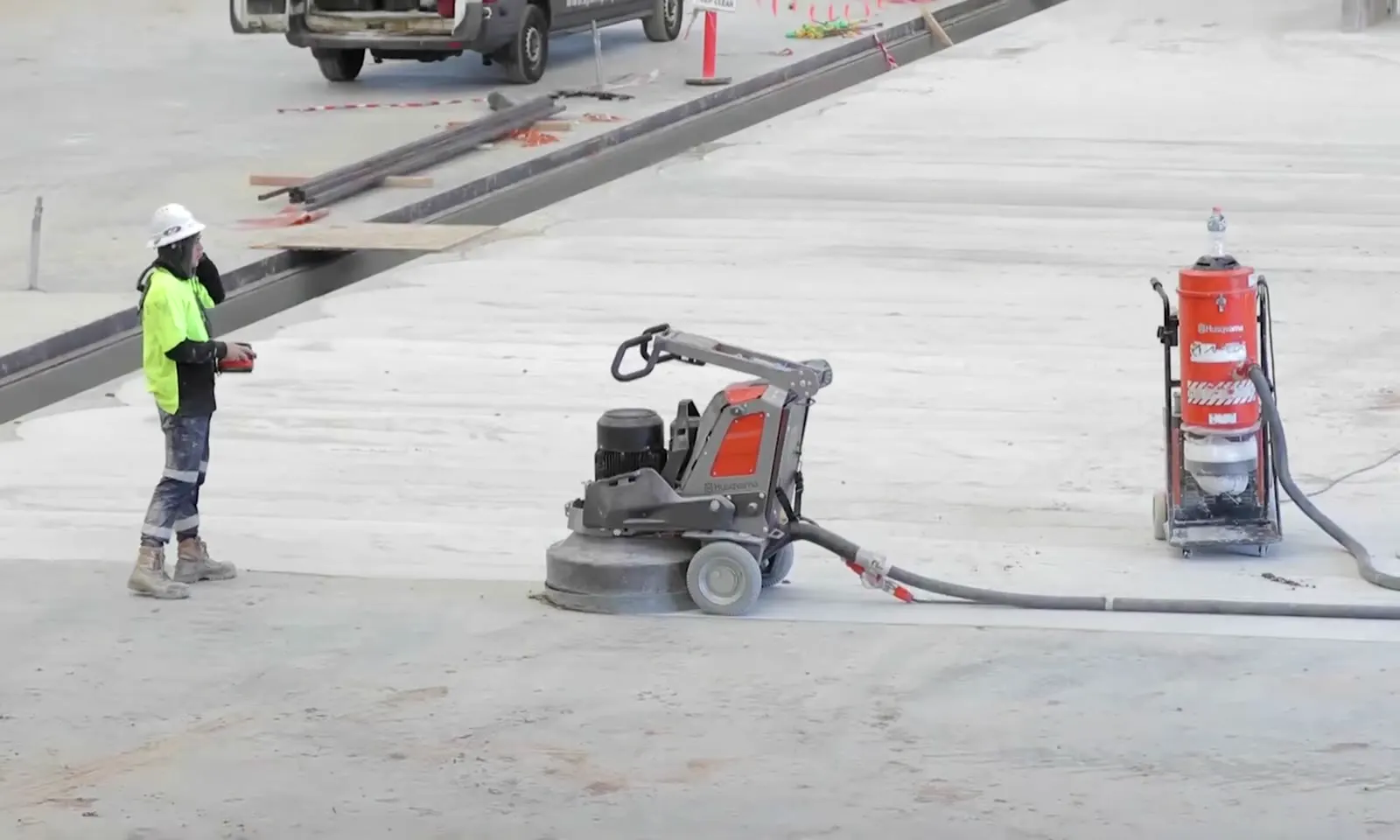 Apex operator running a remote-controlled grinder connected to an H-class dust extractor